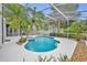 An inviting pool and spa surrounded by lush tropical landscaping create a serene backyard oasis at 2610 Cloudcroft Dr, Apopka, FL 32703