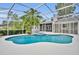View of the pristine pool and spa with screened enclosure and backyard exterior of home at 2610 Cloudcroft Dr, Apopka, FL 32703