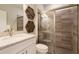 Modern bathroom with a granite countertop vanity, decorative mirror, and a luxurious glass-enclosed shower with seating at 2745 Serenity Meadow Dr, Kissimmee, FL 34744