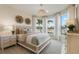 Bright bedroom with a large window view, stylish decor, and neutral color palette at 2745 Serenity Meadow Dr, Kissimmee, FL 34744