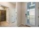 Inviting entryway featuring a decorative front door and a view into a bathroom with a glass-enclosed shower at 2745 Serenity Meadow Dr, Kissimmee, FL 34744