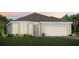 Charming single-story home with a symmetrical facade, a manicured lawn, and an attached two-car garage at 2745 Serenity Meadow Dr, Kissimmee, FL 34744
