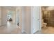Bright hallway with views into the living room and a bathroom featuring a glass-enclosed shower at 2745 Serenity Meadow Dr, Kissimmee, FL 34744