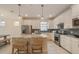 Bright kitchen featuring white cabinetry, stainless steel appliances, and a granite island with seating at 2745 Serenity Meadow Dr, Kissimmee, FL 34744