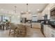Elegant kitchen with granite counters, stainless appliances, white cabinets, and an island with barstool seating at 2745 Serenity Meadow Dr, Kissimmee, FL 34744