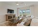 Comfortable living room with shiplap accent wall, plush seating, and sliding glass doors to the backyard at 2745 Serenity Meadow Dr, Kissimmee, FL 34744