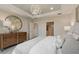 Bright bedroom with tray ceiling, modern light fixture, and access to the en suite bathroom at 2745 Serenity Meadow Dr, Kissimmee, FL 34744