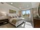 Serene bedroom with large window, decorative lighting, and neutral color palette at 2745 Serenity Meadow Dr, Kissimmee, FL 34744