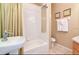 Bathroom featuring a bathtub-shower combo, vanity with sink, and neutral decor at 2918 Sunset Vista Blvd, Kissimmee, FL 34747