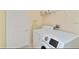 A laundry room features a washer, dryer, shelving, and doorway for simple chore convenience at 2918 Sunset Vista Blvd, Kissimmee, FL 34747