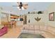 Open-concept living area featuring a ceiling fan, stylish decor, and hardwood flooring at 2918 Sunset Vista Blvd, Kissimmee, FL 34747