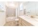 Bathroom featuring a shower-tub combo, large mirror, vanity with sink and cream cabinets at 2988 Salted Rim Rd, Kissimmee, FL 34747
