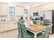 Bright kitchen features stainless steel appliances, white cabinetry, and adjacent dining area at 2988 Salted Rim Rd, Kissimmee, FL 34747