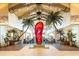 Lobby featuring vaulted ceilings, palm trees, seating areas and a large red flip flop sculpture at 2988 Salted Rim Rd, Kissimmee, FL 34747