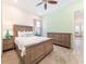 Inviting main bedroom with wood floors, dresser, bedside tables and a large bed at 2988 Salted Rim Rd, Kissimmee, FL 34747