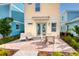 Back patio featuring a dining table with chairs, two lounge chairs and colorful landscaping at 2988 Salted Rim Rd, Kissimmee, FL 34747