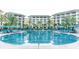 Luxurious resort pool area with comfortable lounge chairs, umbrellas, palm trees, and clear blue water for an ideal retreat at 2988 Salted Rim Rd, Kissimmee, FL 34747
