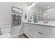Modern bathroom with dual sinks, a quartz countertop, and decorative towels with a vanity at 3078 Isles Way, New Smyrna Beach, FL 32168