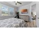 Cozy bedroom with a dresser, TV, and a window offering natural light and view of the outside at 3078 Isles Way, New Smyrna Beach, FL 32168