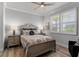 Well-lit bedroom with a classic wooden bed frame, matching nightstands, and light streaming through shuttered windows at 3078 Isles Way, New Smyrna Beach, FL 32168