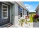Home exterior features light gray paint, dark shutters and beautiful landscaping at 3078 Isles Way, New Smyrna Beach, FL 32168