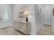 Entryway features a decorative cabinet, coastal artwork and light wood flooring at 3078 Isles Way, New Smyrna Beach, FL 32168