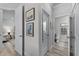 Hallway leading to adjacent rooms, features soothing artwork and modern doors at 3078 Isles Way, New Smyrna Beach, FL 32168