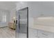 Kitchen features a stainless steel refrigerator, white shaker cabinets, and stone countertops at 3078 Isles Way, New Smyrna Beach, FL 32168