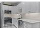 Modern kitchen boasts white cabinetry, quartz countertops, and stainless steel appliances at 3078 Isles Way, New Smyrna Beach, FL 32168