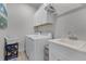 Laundry room featuring new washer, dryer, utility sink, and plenty of storage at 3078 Isles Way, New Smyrna Beach, FL 32168