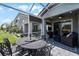 Covered patio with comfortable seating, a ceiling fan, and views of the landscaped backyard and home at 3078 Isles Way, New Smyrna Beach, FL 32168