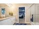 Stylish bathroom with double sinks, white cabinets, granite countertop and glass shower at 3242 Viceroy Ct, Poinciana, FL 34759