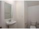Powder room features a pedestal sink, mirror, and a toilet at 3242 Viceroy Ct, Poinciana, FL 34759