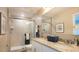 Bathroom featuring double sinks, granite countertop, glass-enclosed shower with subway tile at 3242 Viceroy Ct, Poinciana, FL 34759