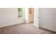 Bedroom with carpet flooring, a window, and a door leading to the en-suite bathroom at 3242 Viceroy Ct, Poinciana, FL 34759