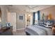 Nautical themed bedroom features a coastal style accent wall, ceiling fan and ensuite bathroom at 3242 Viceroy Ct, Poinciana, FL 34759
