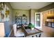 Well-lit home office featuring custom shelves, decorative world map art and a wooden desk at 3242 Viceroy Ct, Poinciana, FL 34759