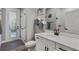 Bright bathroom features a white vanity with framed mirror, stylish fixtures, and an entry door at 3332 Lone Cypress Pt, Oviedo, FL 32765