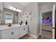 Bright bathroom with double sinks, decorations and an attached room at 3332 Lone Cypress Pt, Oviedo, FL 32765