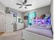 Comfortable bedroom featuring a white bed frame with LED lights and a shelf for stuffed animals and decor at 3332 Lone Cypress Pt, Oviedo, FL 32765