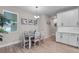 Bright eat-in kitchen area with white cabinetry and view from the large window at 3332 Lone Cypress Pt, Oviedo, FL 32765
