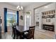 Dining room with wood table, blue curtains, hardwood floors and view of home entryway at 3332 Lone Cypress Pt, Oviedo, FL 32765