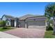 This beautiful home boasts an attached three-car garage and an inviting exterior with lush landscaping and charming details at 3332 Lone Cypress Pt, Oviedo, FL 32765
