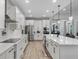 Spacious kitchen featuring white cabinetry, stainless steel appliances, and an island with a sink at 3332 Lone Cypress Pt, Oviedo, FL 32765