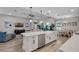 Open concept living space featuring a spacious kitchen island, dining area, and comfortable living room with natural light at 3332 Lone Cypress Pt, Oviedo, FL 32765