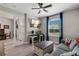 Open concept living room with desk, television, modern decor, and comfortable seating at 3332 Lone Cypress Pt, Oviedo, FL 32765