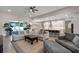 Spacious living room with a large sectional sofa, pool view and open concept kitchen at 3332 Lone Cypress Pt, Oviedo, FL 32765