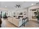 Open living room with hardwood floors, ceiling fan, and modern decor for a bright and airy atmosphere at 3332 Lone Cypress Pt, Oviedo, FL 32765