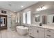 Luxurious bathroom with a standalone tub, glass shower and double sinks at 3332 Lone Cypress Pt, Oviedo, FL 32765