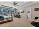 Bright main bedroom with a ceiling fan and patio access at 3332 Lone Cypress Pt, Oviedo, FL 32765